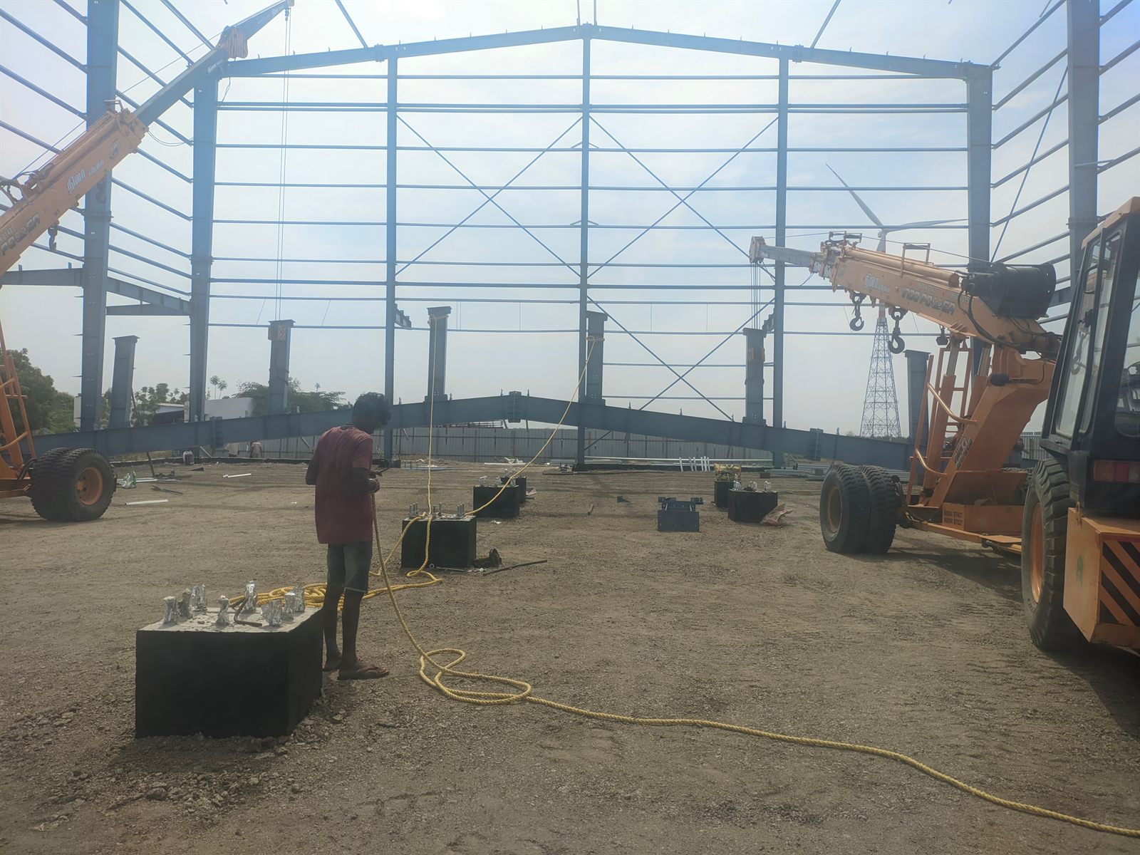 Anchor bolts set in the pedestals, ready for the columns being craned in behind