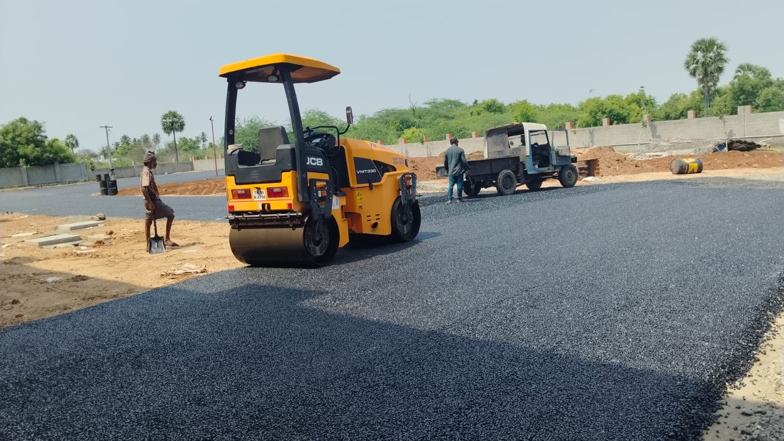 A full-width run of new bituminous surfacing being rolled out across the site