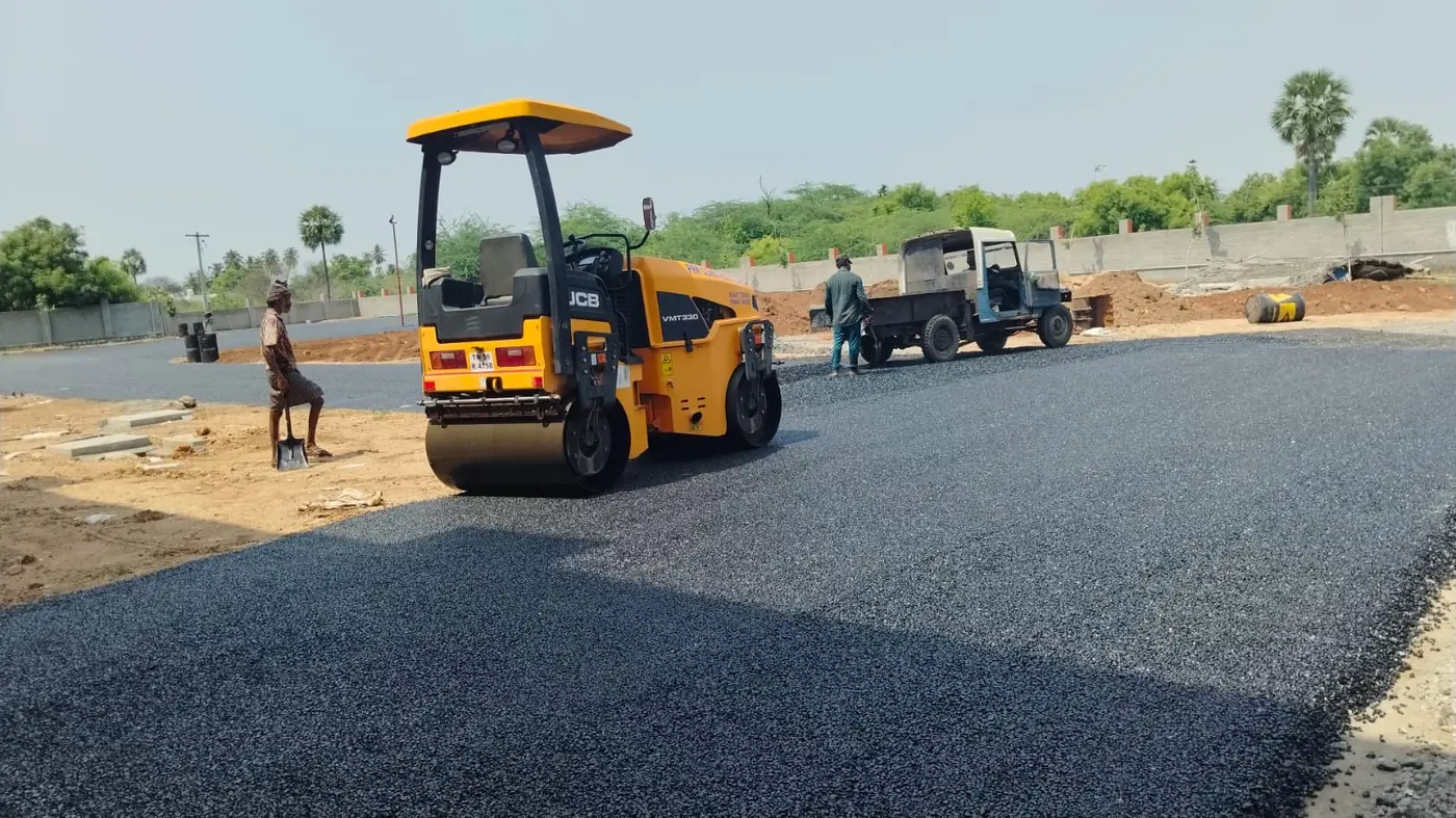 A full-width run of new bituminous surfacing being rolled out across the site