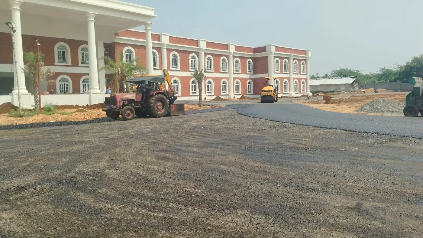 The long classroom wing seen from the far end of the campus approach