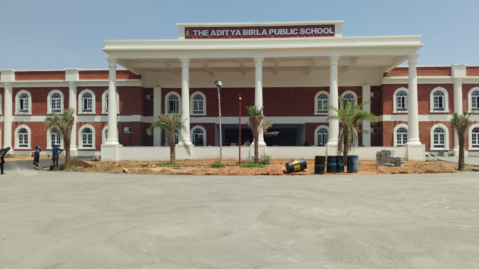 The Aditya Birla Public School - the finished two-storey brick and white block behind its new forecourt