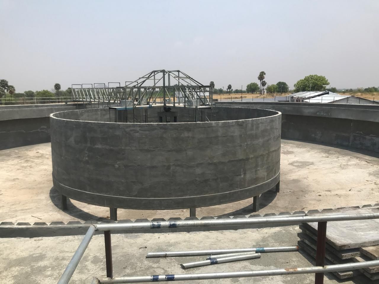 The completed circular clarifier, its walkway bridge set across the centre well