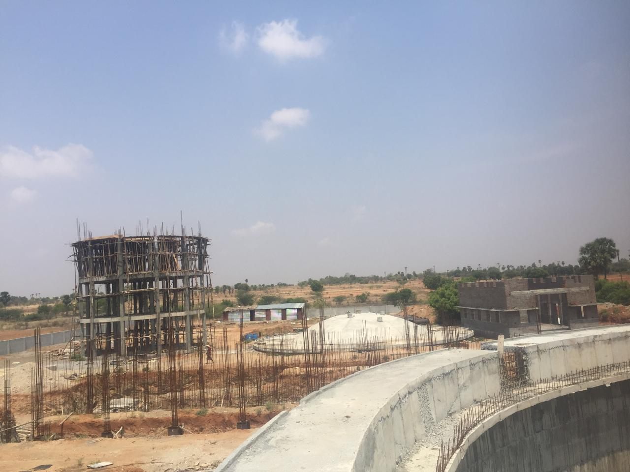 The plant site from the tank wall - staging, settled domes and the operator block beyond