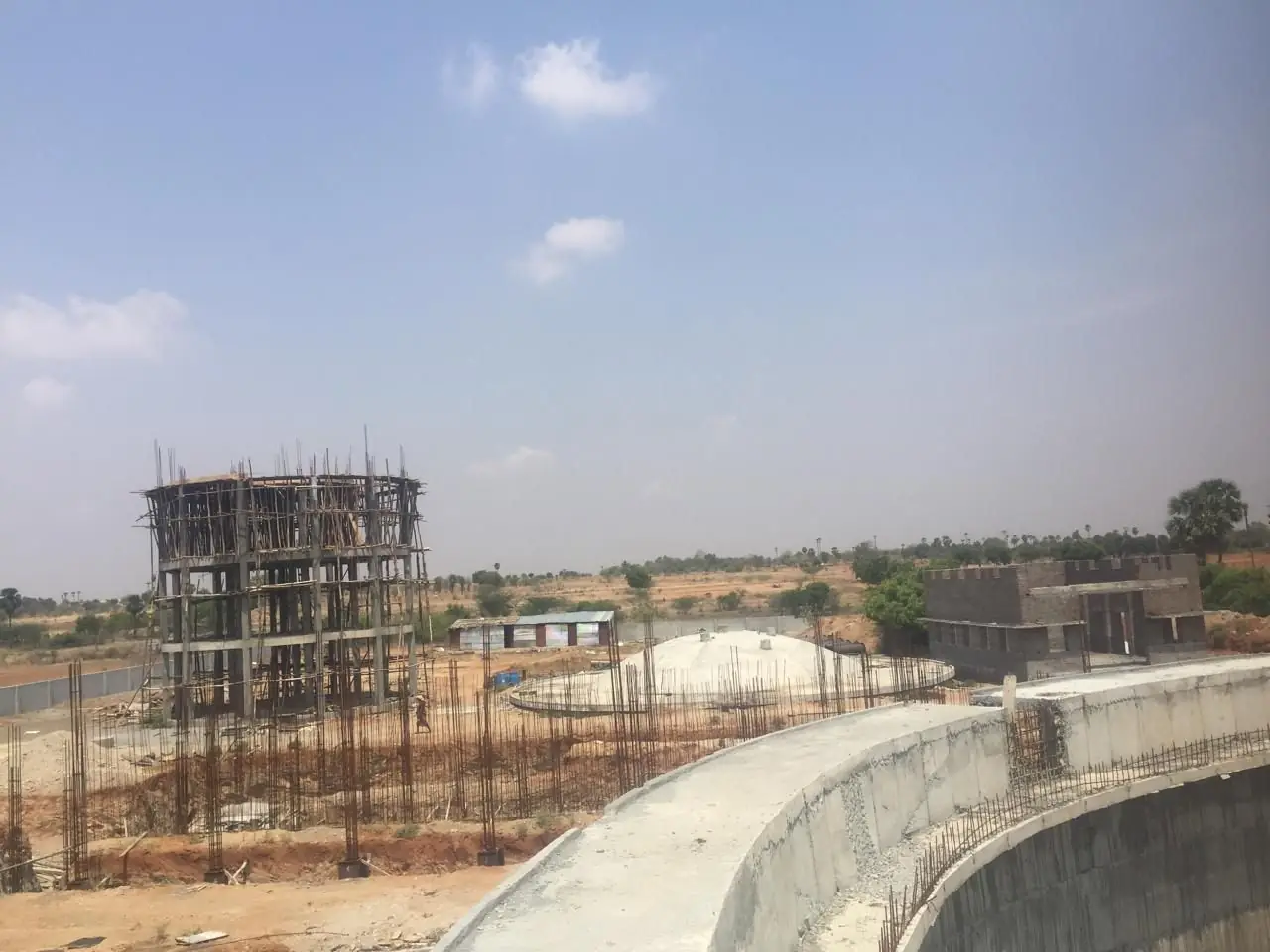The plant site from the tank wall - staging, settled domes and the operator block beyond
